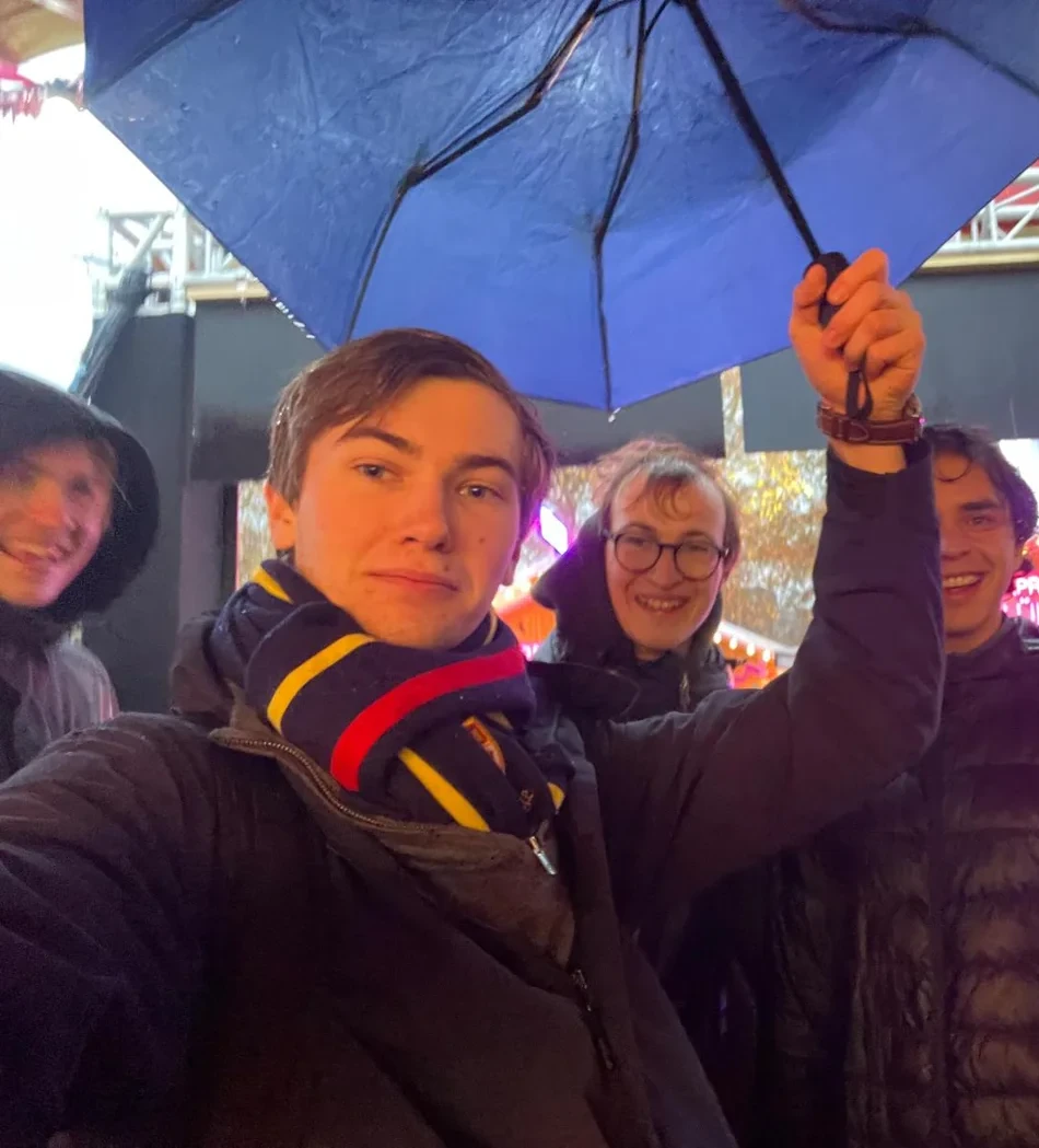 People beneath an umbrella at night