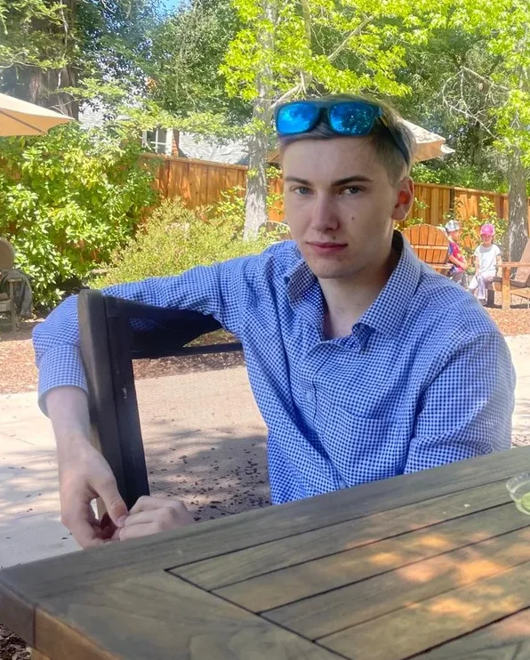 Atticus seated at an outdoor table